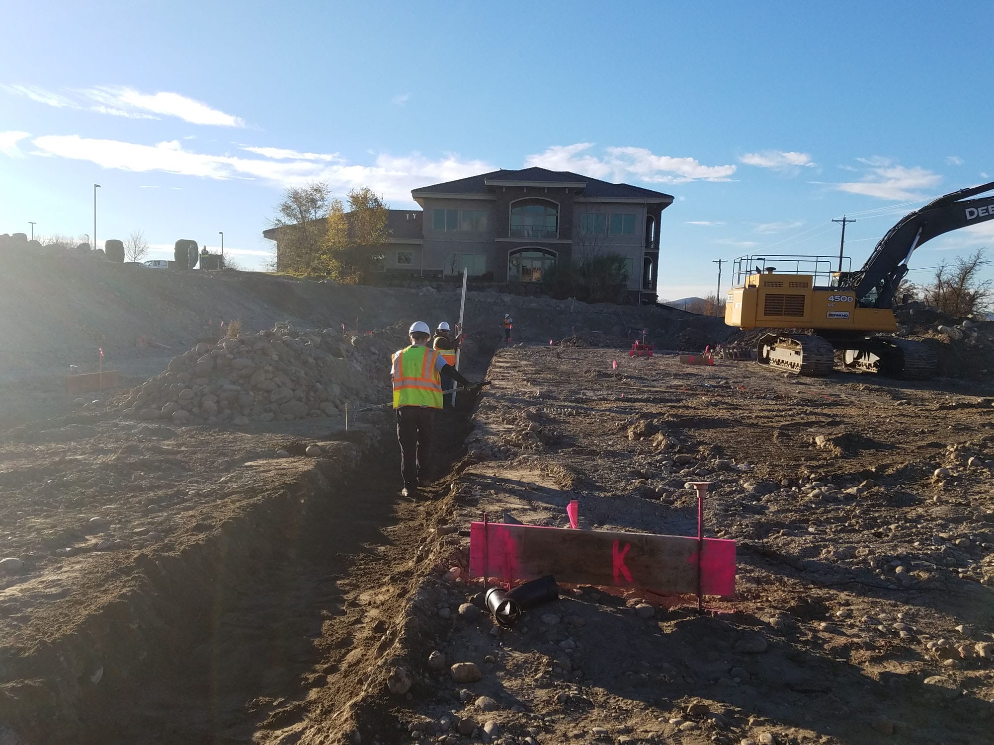 sewer-line-repair Construction site with workers and excavator
