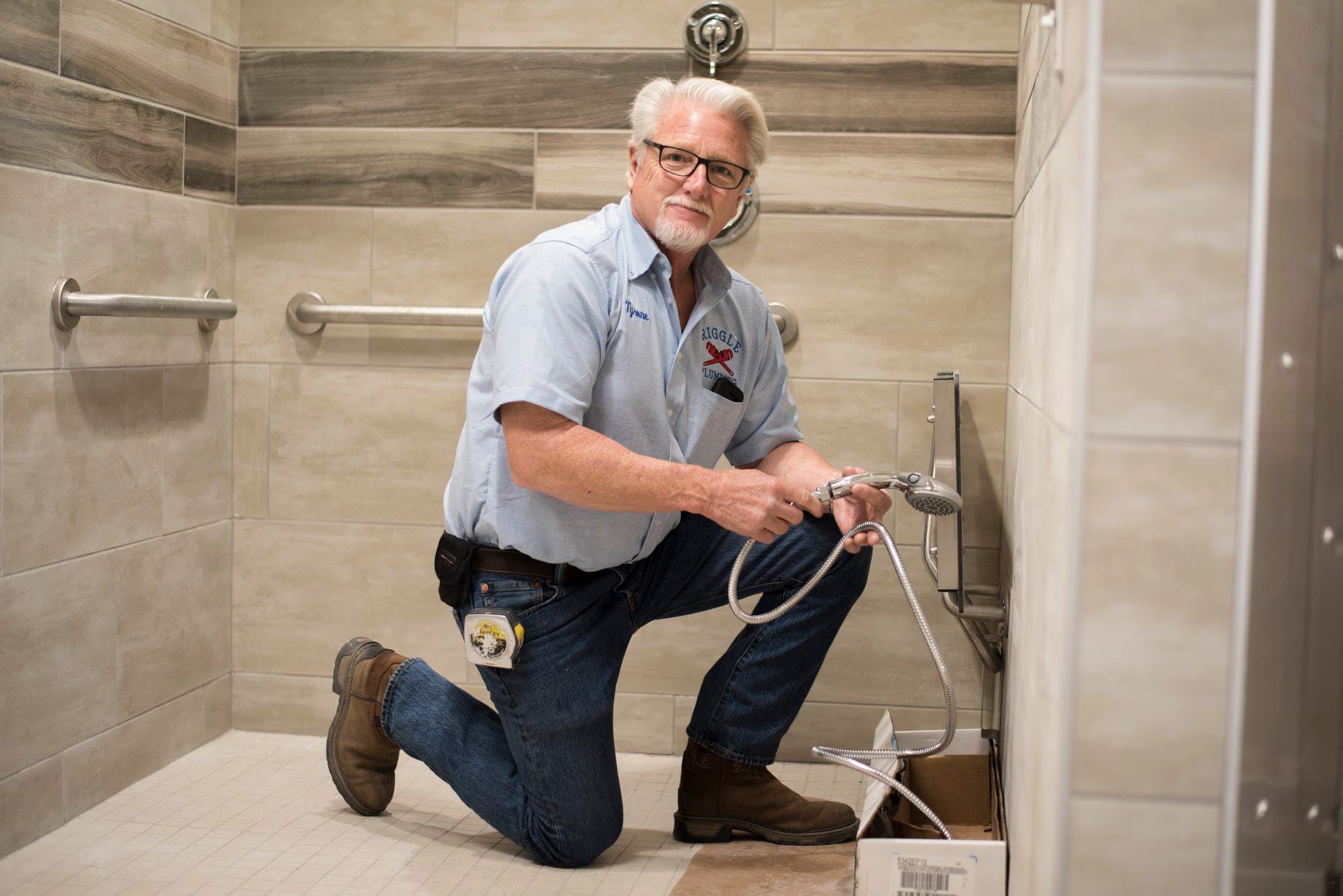 43304724_1901066076608808_1938726930081644544_n Plumber fixing shower in bathroom.