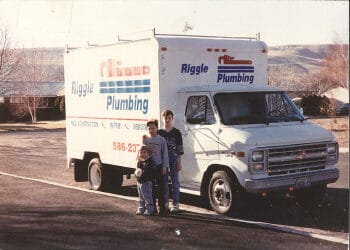 Family standing by Riggle Plumbing van