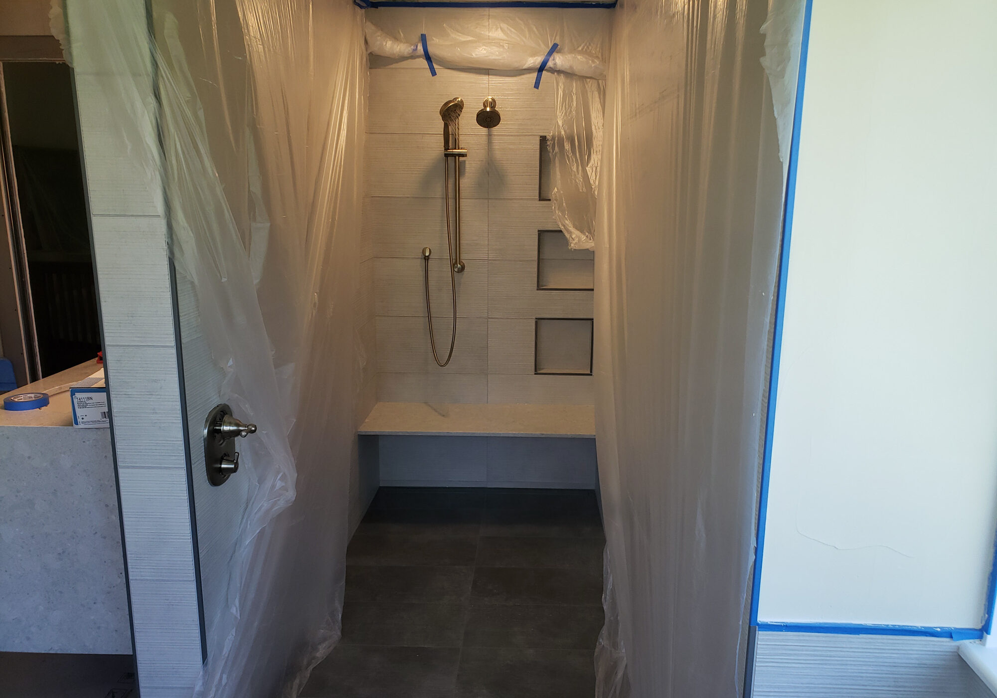 20210618_142821 Shower area under renovation with plastic coverings.